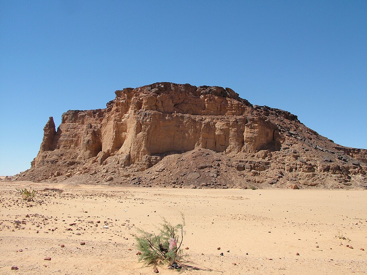 Gebel Barkal sacred mountain rising above the Sudanese desert near Karima, with ancient Nubian pyramids in the foreground