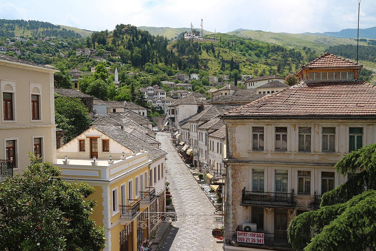 The stone-roofed Ottoman tower houses of Gjirokastër, Albania, rising above the city on a steep hillside with the castle above