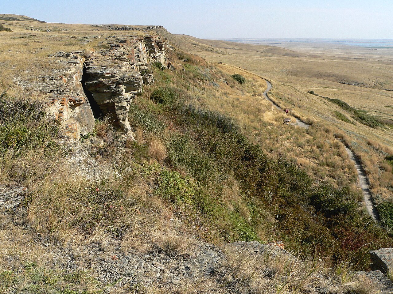 The sandstone cliff face at Head-Smashed-In Buffalo Jump, Alberta, Canada — used continuously for 5,800 years to drive bison off the 10-metre drop