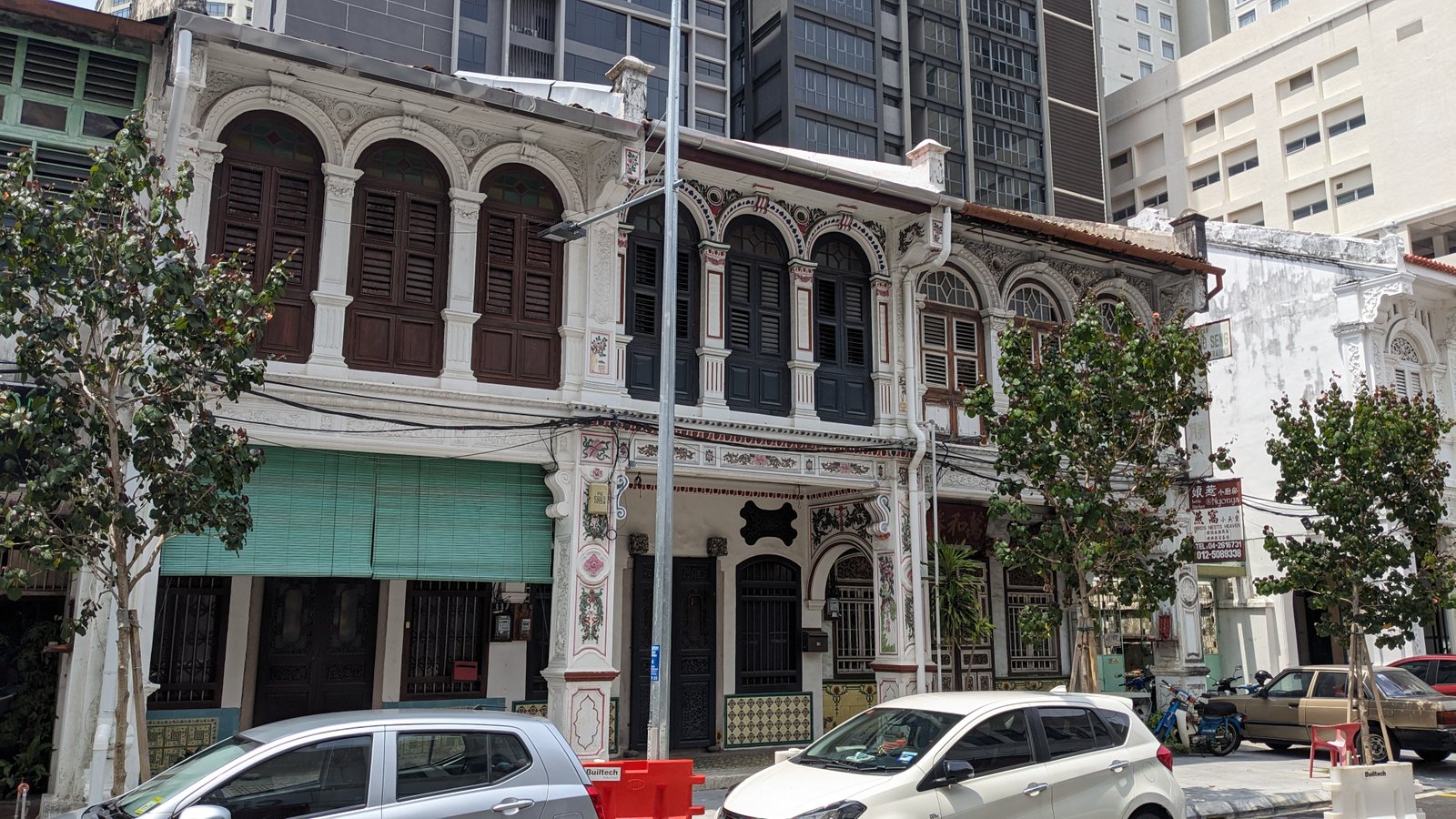 Row of low-rise colonial-era shophouses along a street in central George Town, Penang