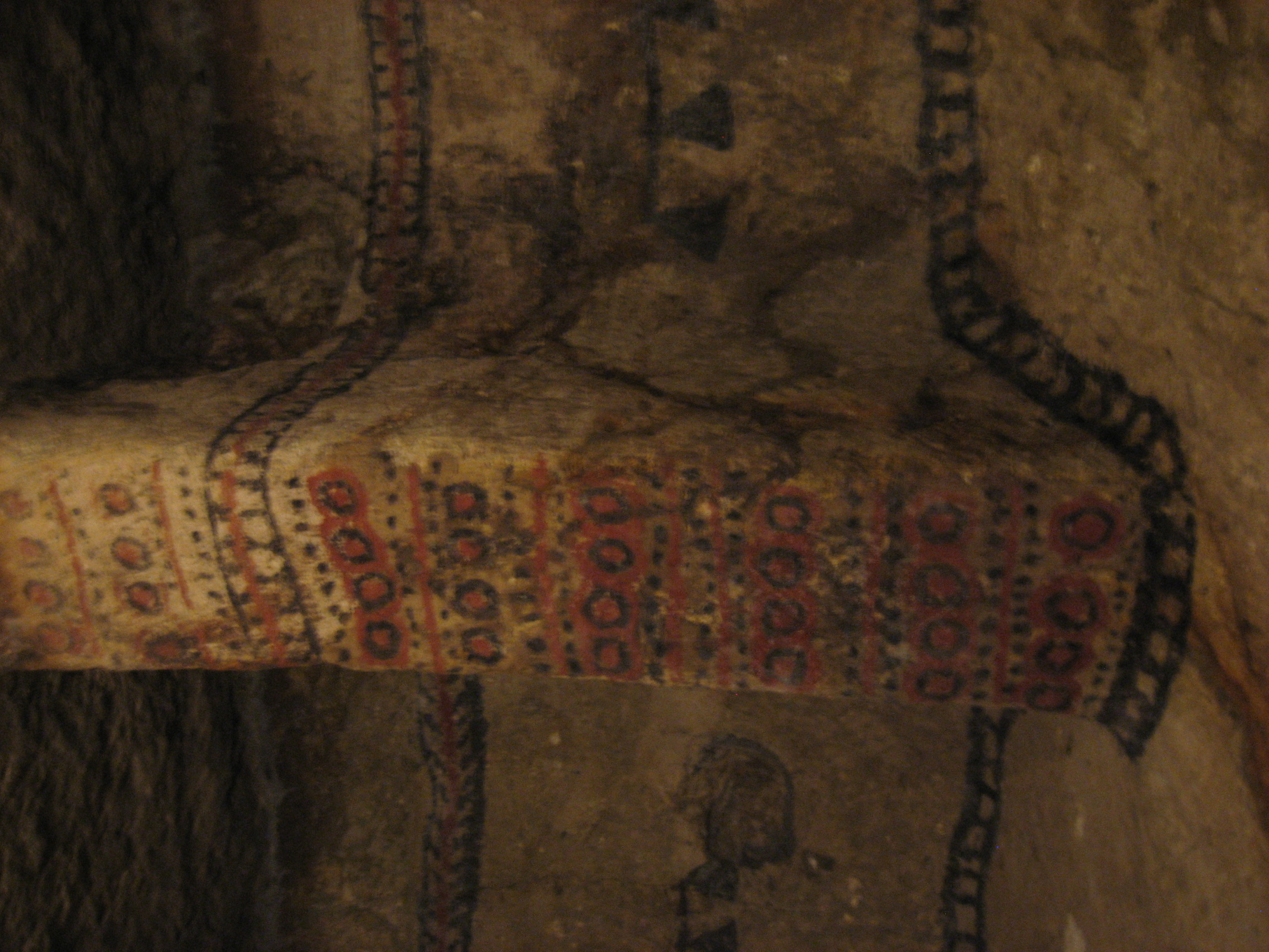 Painted red and white geometric patterns on the interior walls of a Tierradentro hypogeum burial chamber