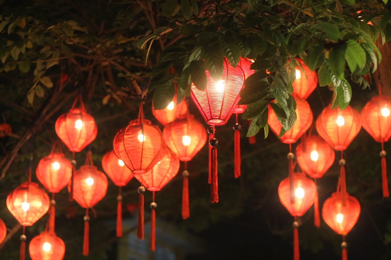 Coloured paper lanterns hanging over the narrow streets of Hội An Ancient Town, Vietnam — the silk and lantern-making tradition of the historic merchant port city on the Thu Bồn River, a UNESCO World Heritage Site since 1999 CE