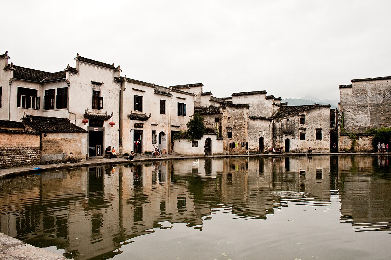 Hongcun village reflected in Moon Pond traditional white-walled architecture Anhui China