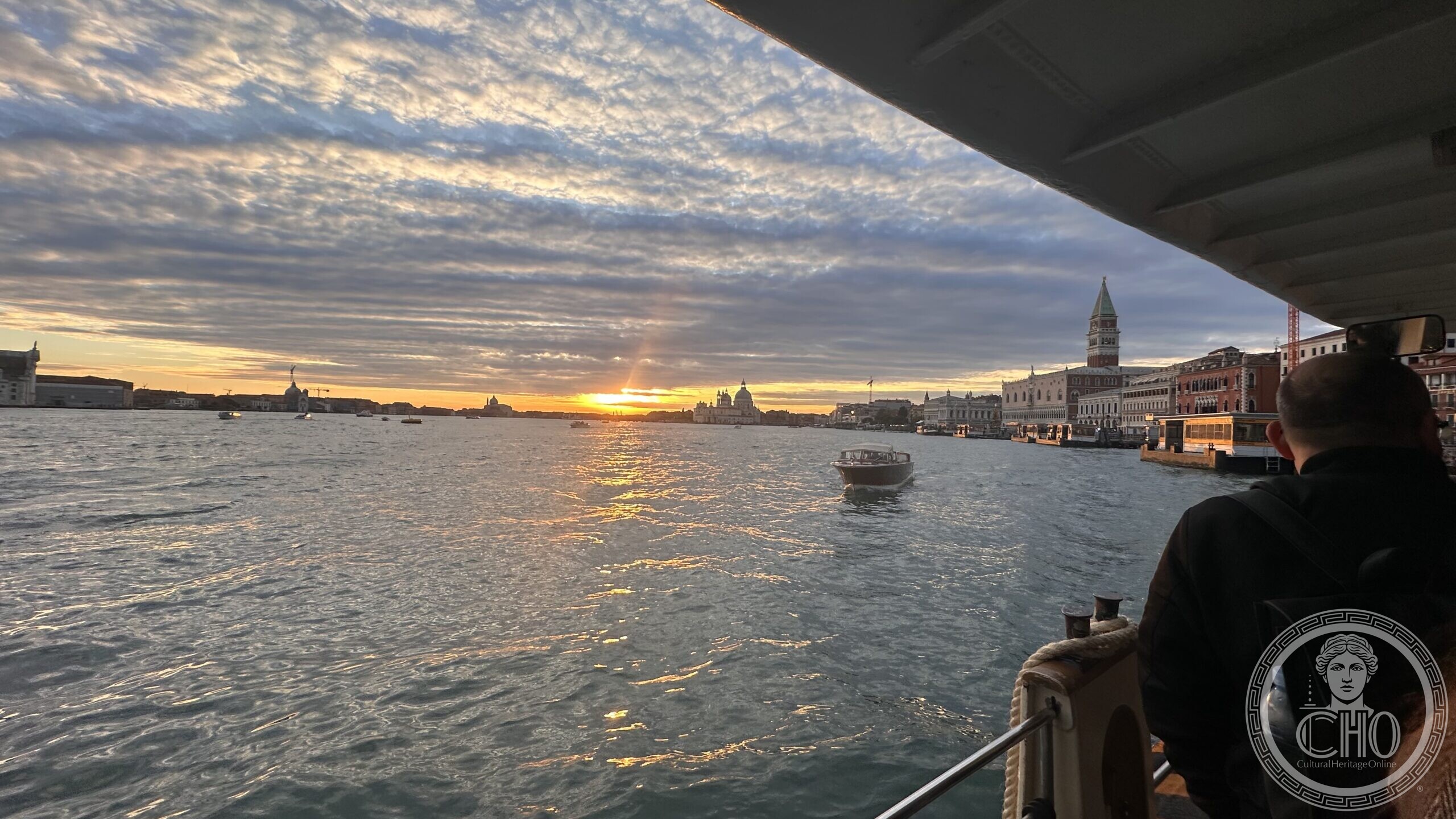 Arriving by boat at sunrise toward Piazza San Marco, with the Campanile and Doge's Palace ahead