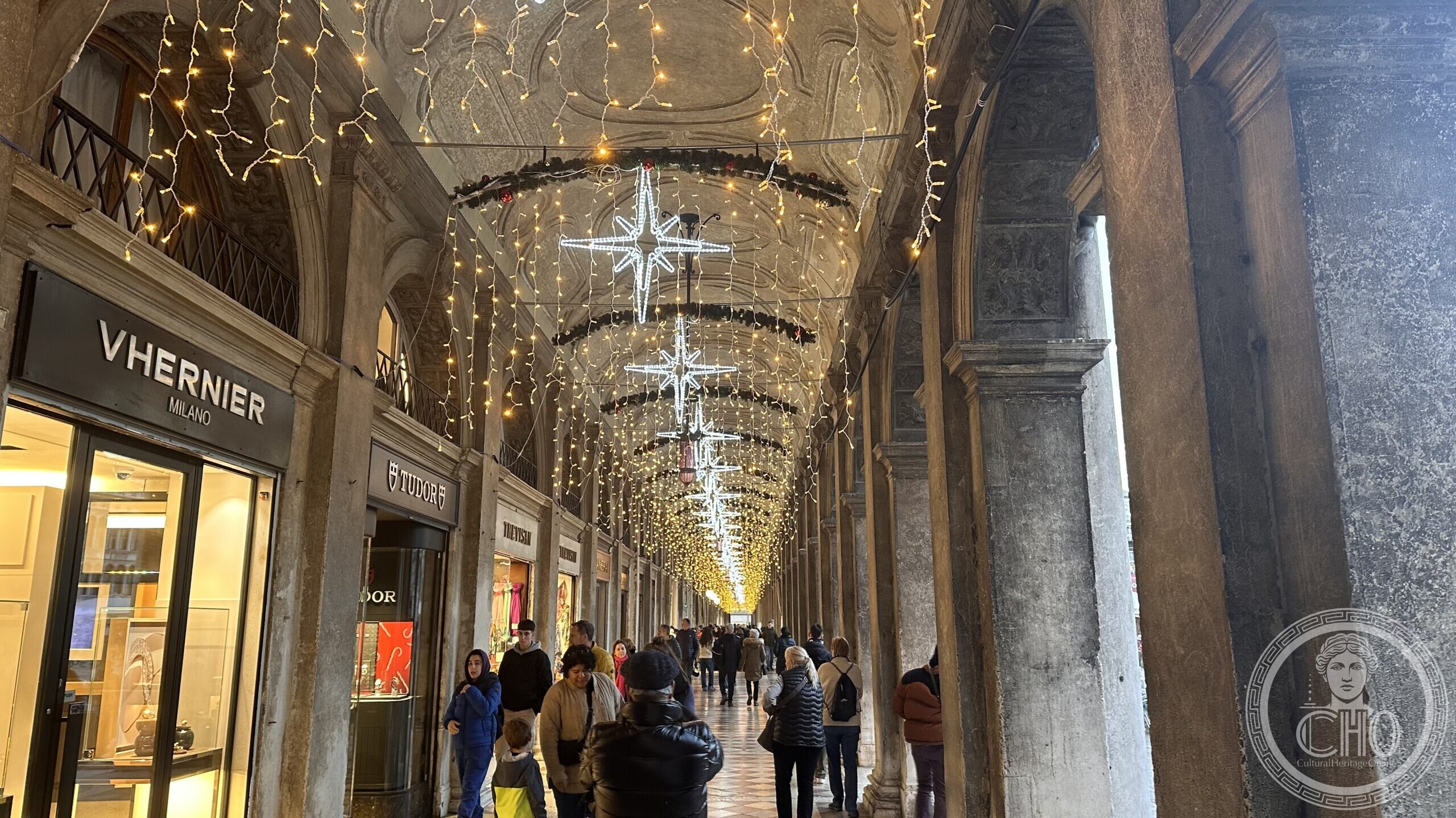 The arcade of the Procuratie Vecchie in Piazza San Marco decorated with Christmas lights and stars