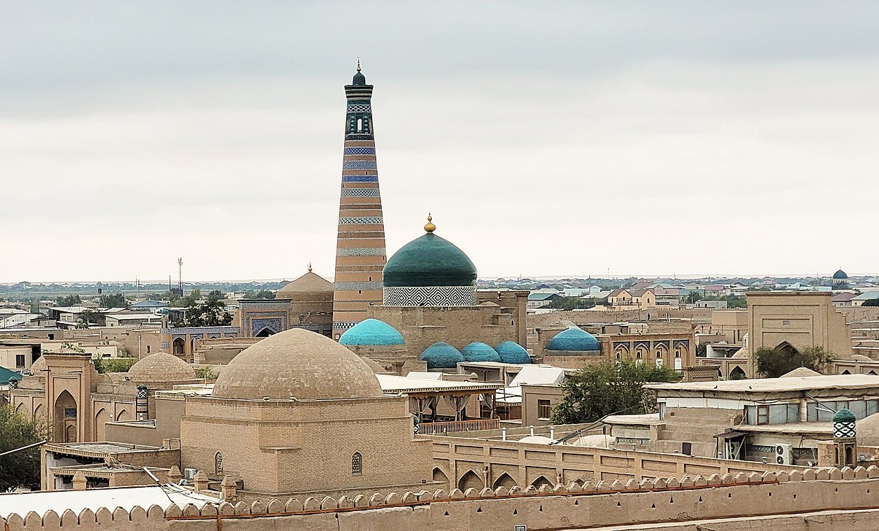 The Islam Khodja Madrasa and its slender minaret rising above the rooftops of Itchan Kala, the walled inner city of Khiva in Uzbekistan
