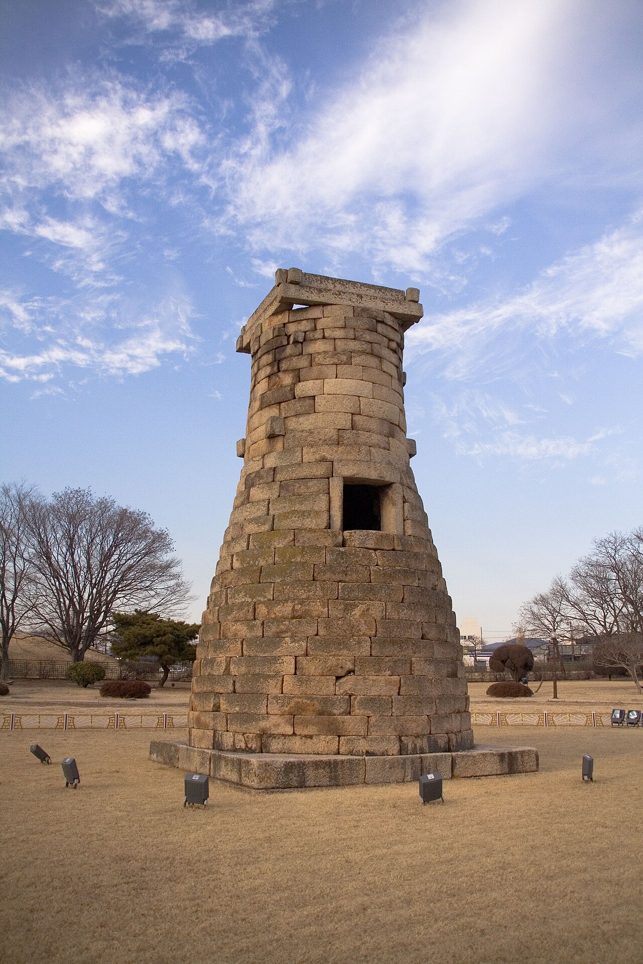 Cheomseongdae Observatory, a 7th-century CE bottle-shaped granite astronomical tower standing in an open field in Gyeongju, South Korea — the oldest surviving astronomical observatory in East Asia, built during the reign of Silla Queen Seondeok