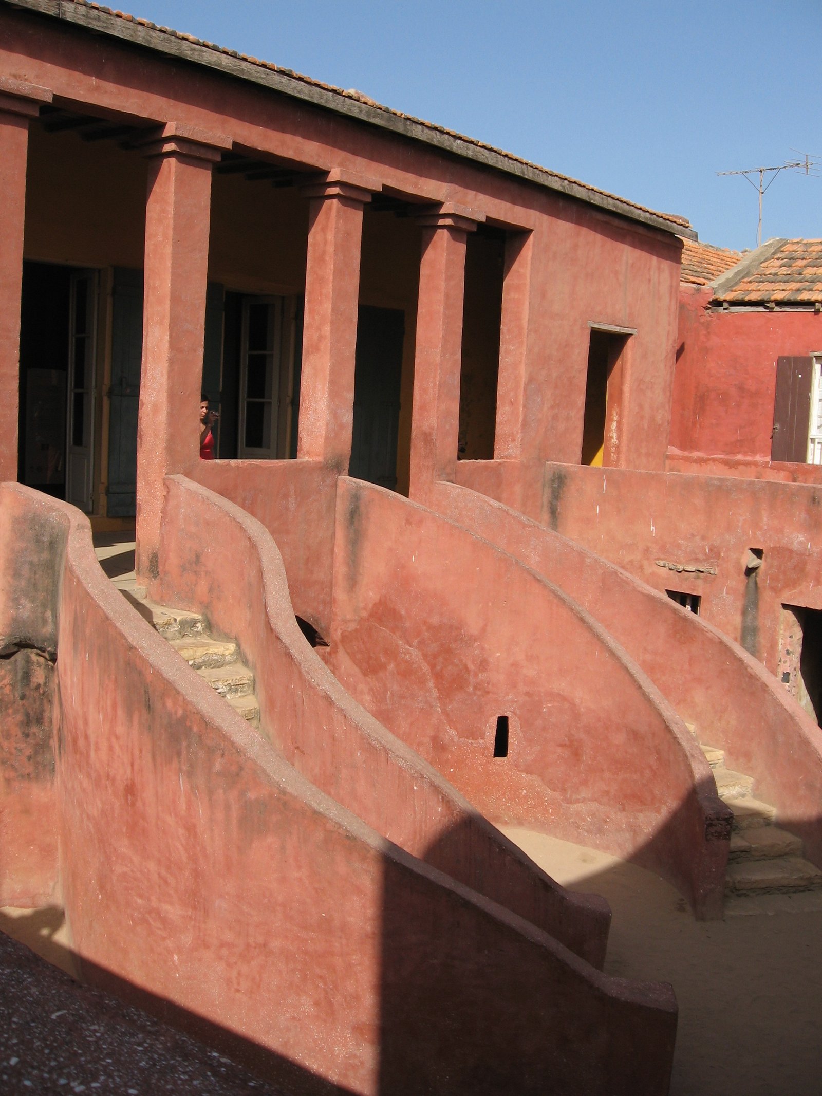 Maison des Esclaves on Gorée Island, pink facade with twin staircases and the Door of No Return