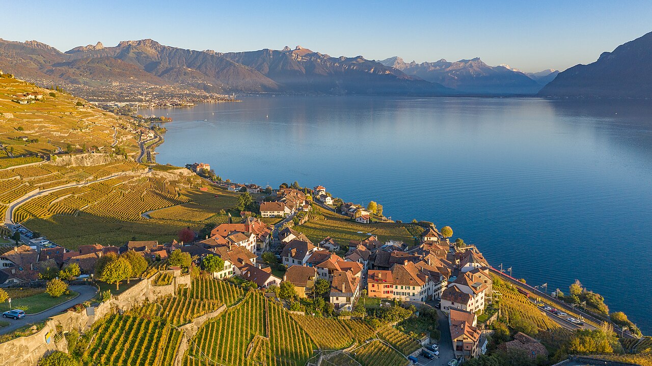 Lavaux vineyard terraces stepping down towards Lake Geneva with the Alps visible across the water, Vaud, Switzerland