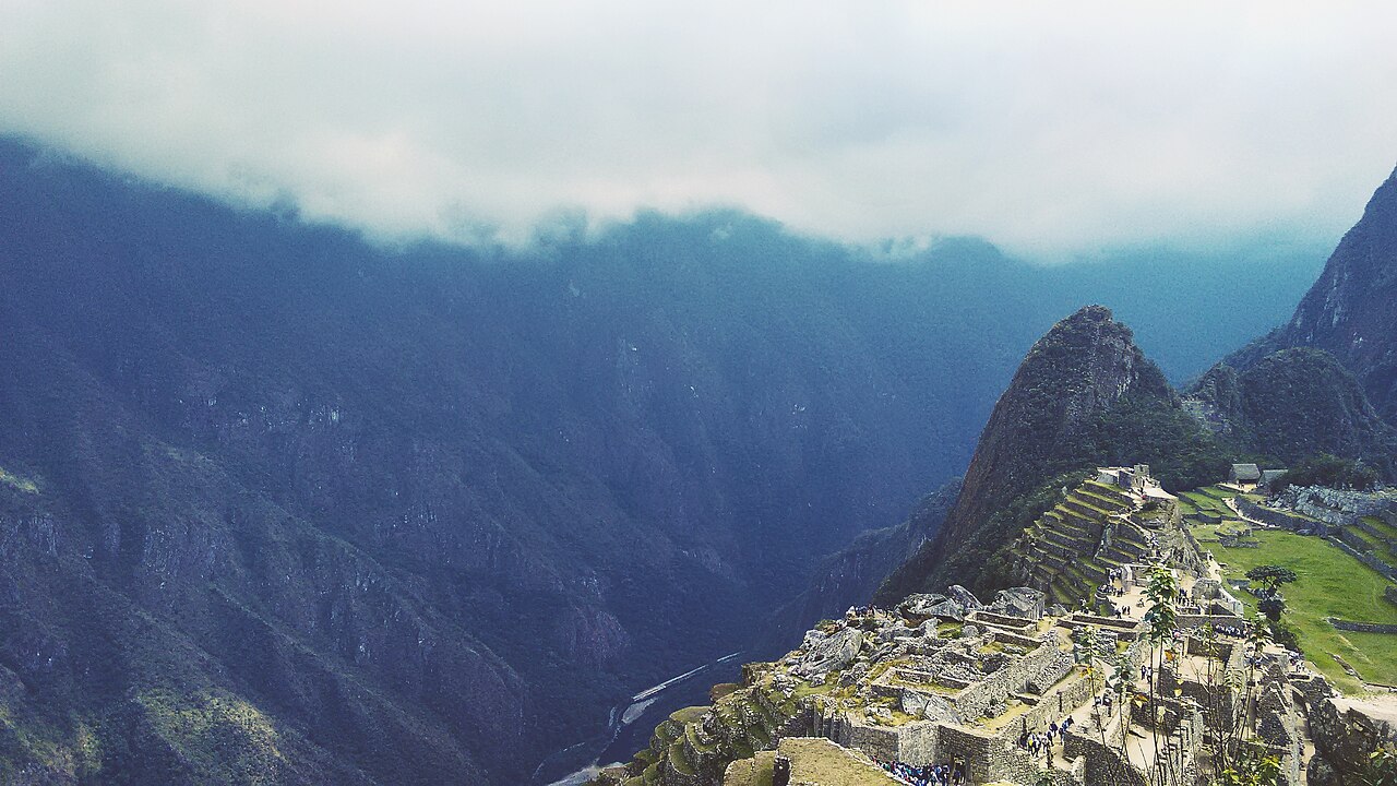 Stone ruins of Machu Picchu citadel set against dramatic Andean mountain peaks