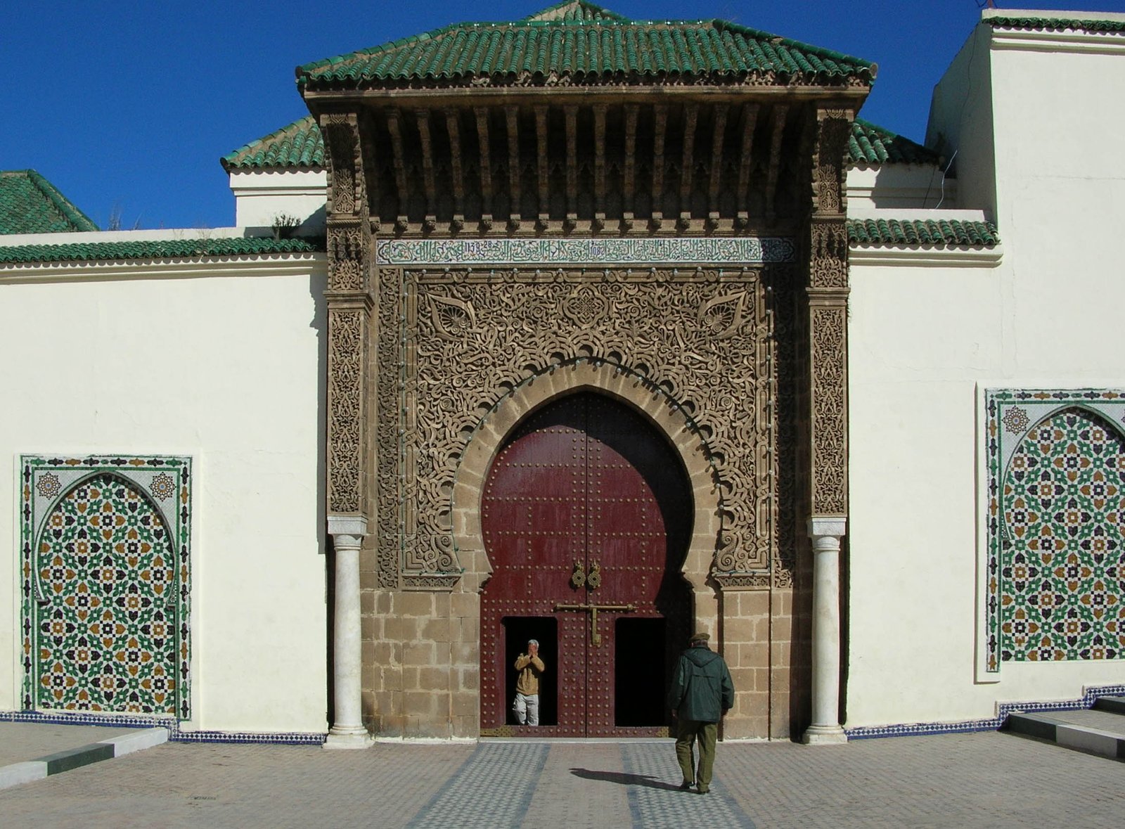 Ornate interior courtyard of the Mausoleum of Moulay Ismail in Meknes with arched galleries