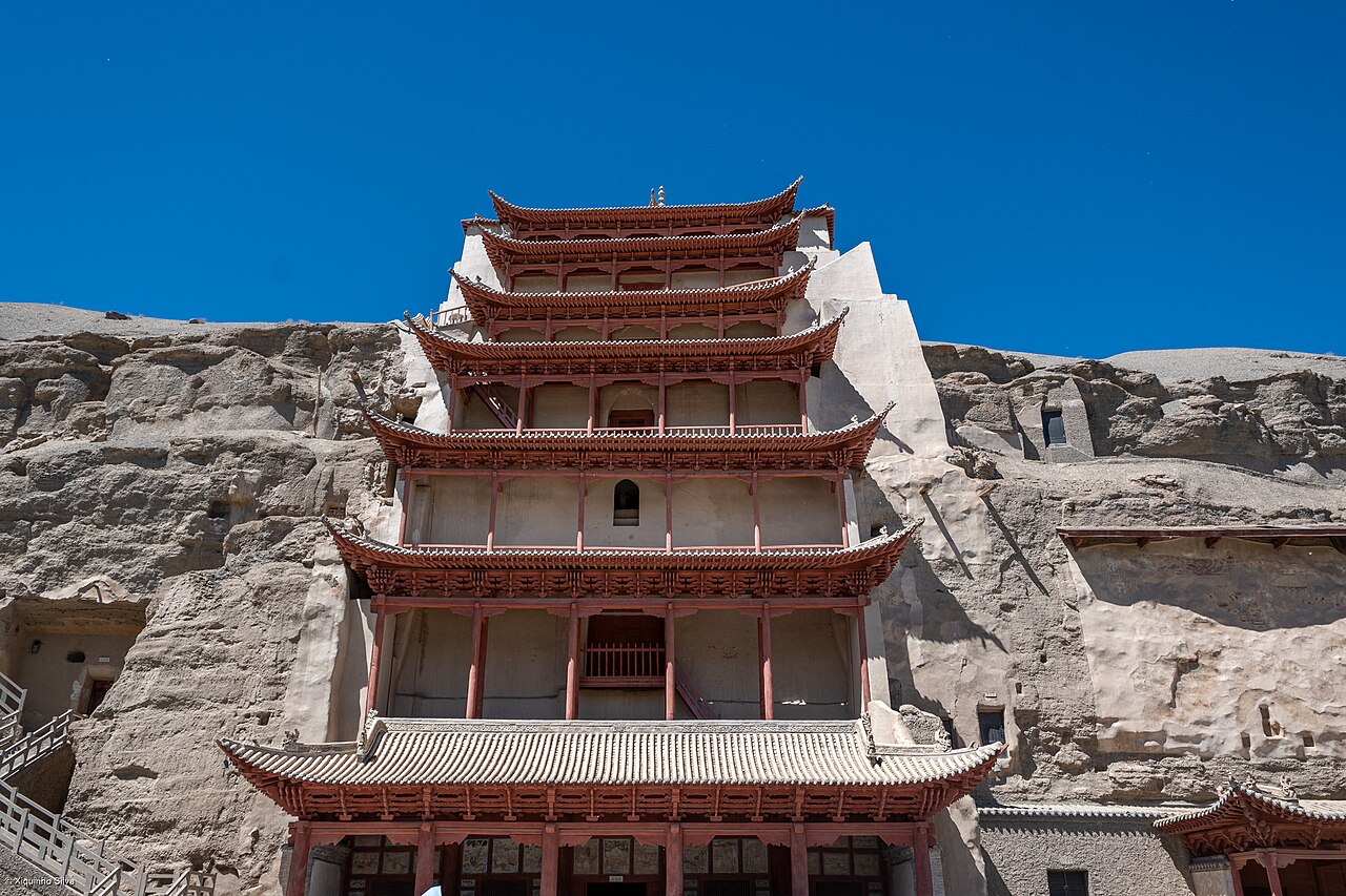 The cliff face of the Mogao Caves near Dunhuang, Gansu, China — a honeycomb of Buddhist cave shrines carved from the 4th to 14th centuries, containing the world's largest collection of Buddhist art
