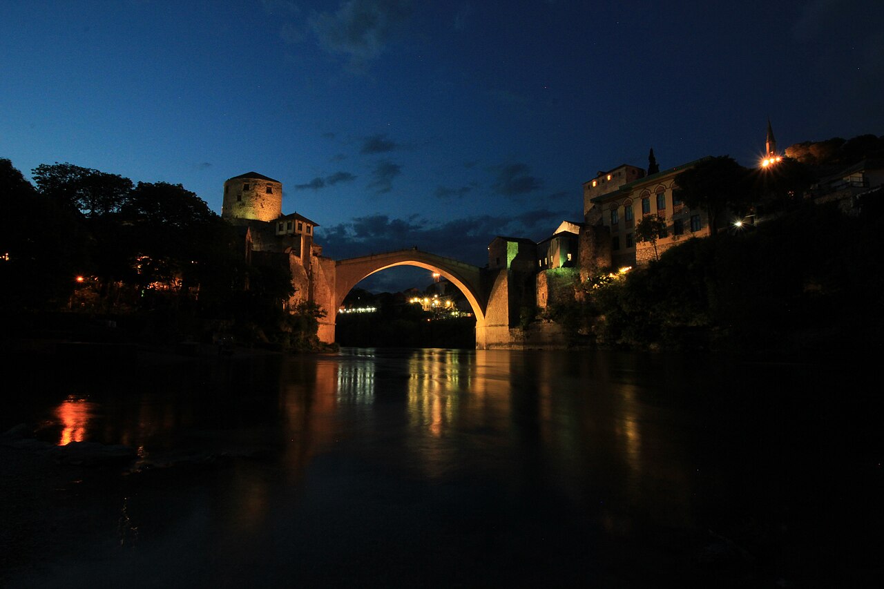 Stari Most single-span limestone arch reflected in the Neretva River below