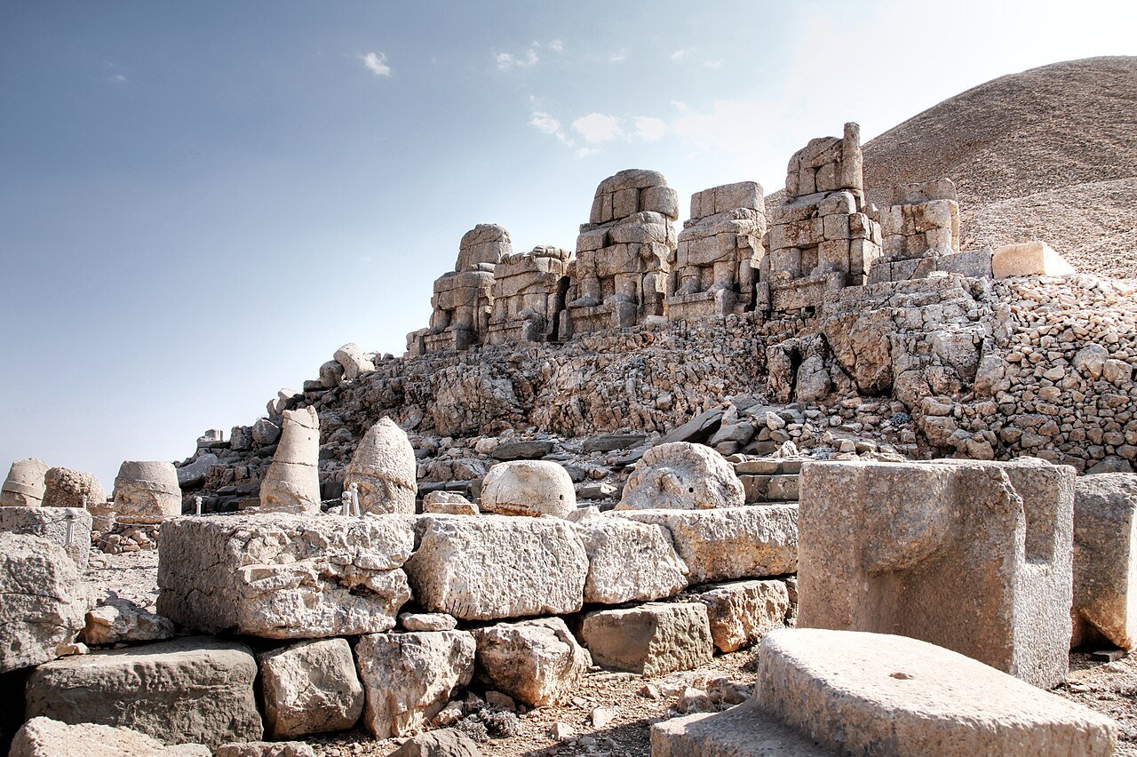 Row of colossal stone heads with mountain summit tumulus at Mount Nemrut East Terrace