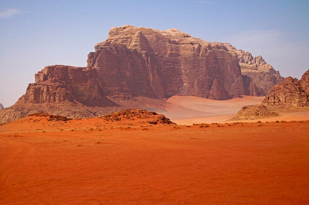 The red sandstone and granite mountains of Wadi Rum, Jordan — a desert protected area with Nabataean inscriptions, natural arches, and the landscape where T.E. Lawrence led the Arab Revolt in 1917