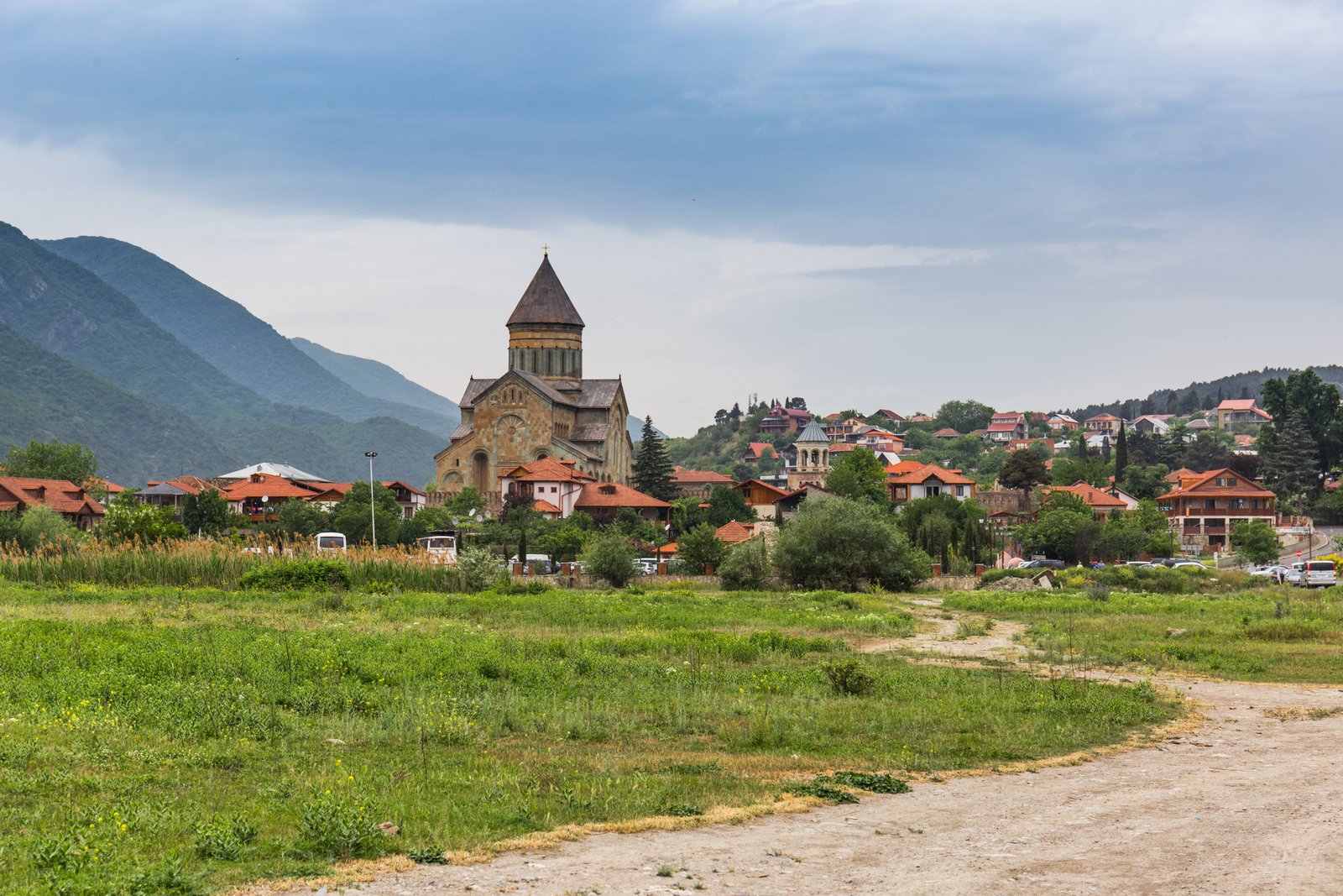 Svetitskhoveli Cathedral rising above the rooftops of Mtskheta with green hills behind