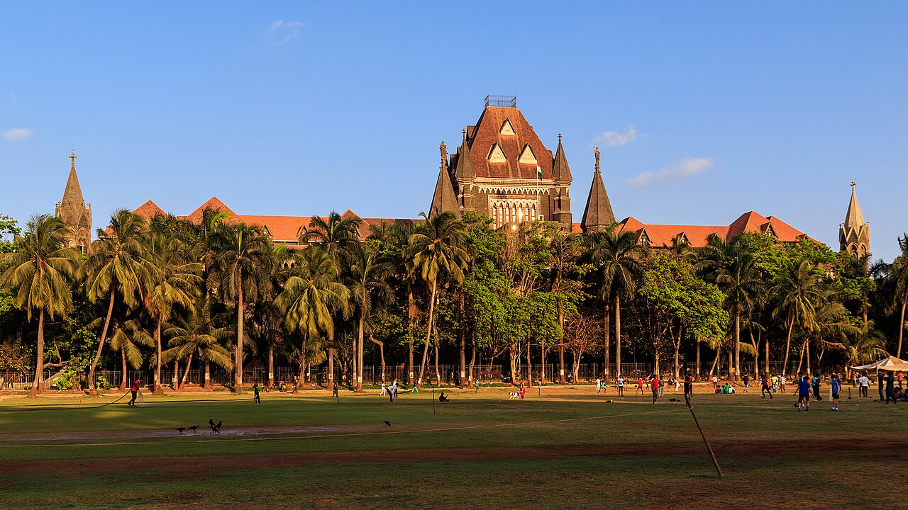 The Bombay High Court (1878 CE) in Mumbai, Maharashtra, India — one of the Victorian Gothic buildings of the Victorian Gothic and Art Deco Ensembles of Mumbai, inscribed by UNESCO in 2018, built in Venetian Gothic style with carved stone tracery, towers, and a statue of Themis at the apex, by Colonel J.A. Fuller of the Royal Engineers