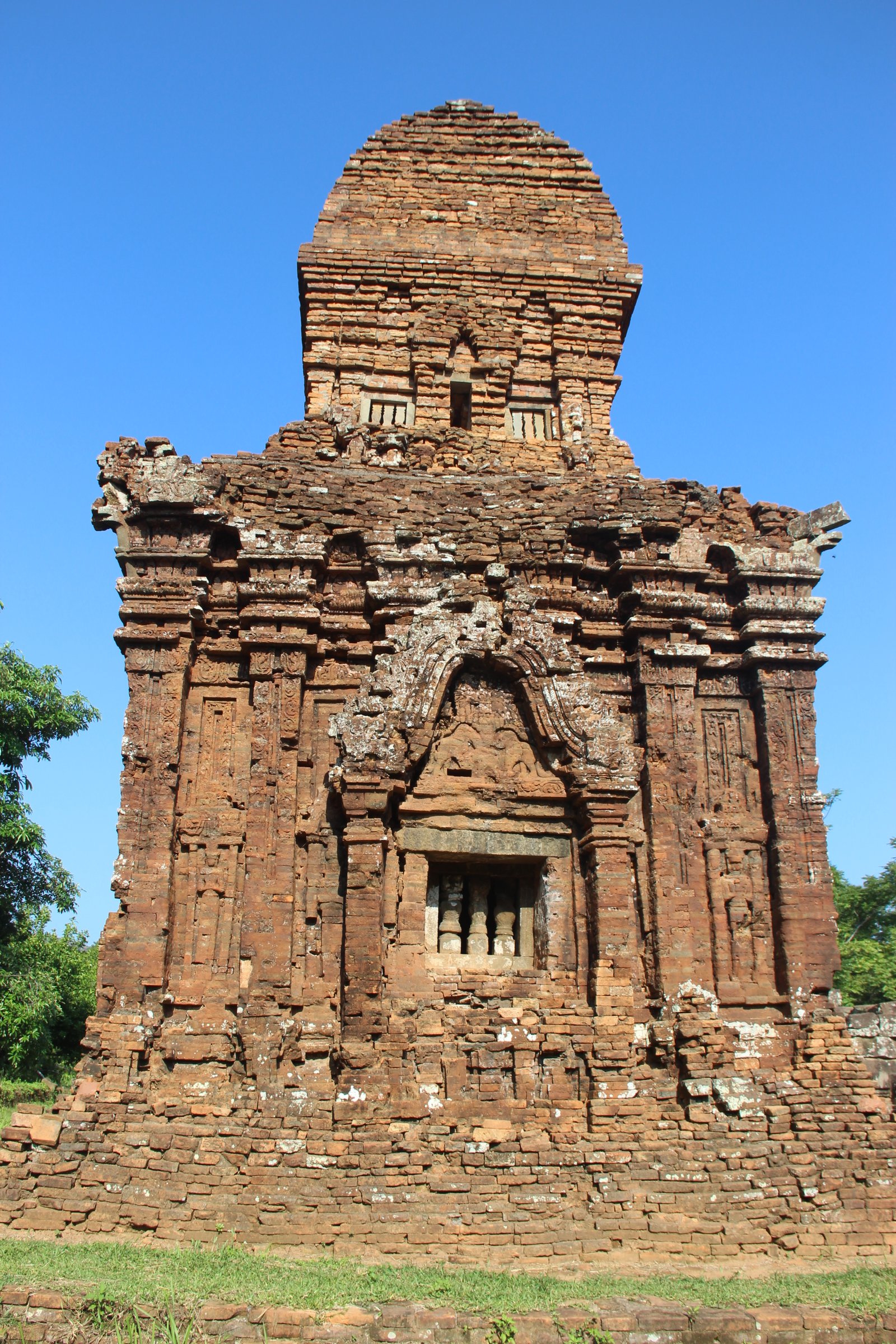 Red-brick Cham temple towers at My Son Sanctuary surrounded by jungle