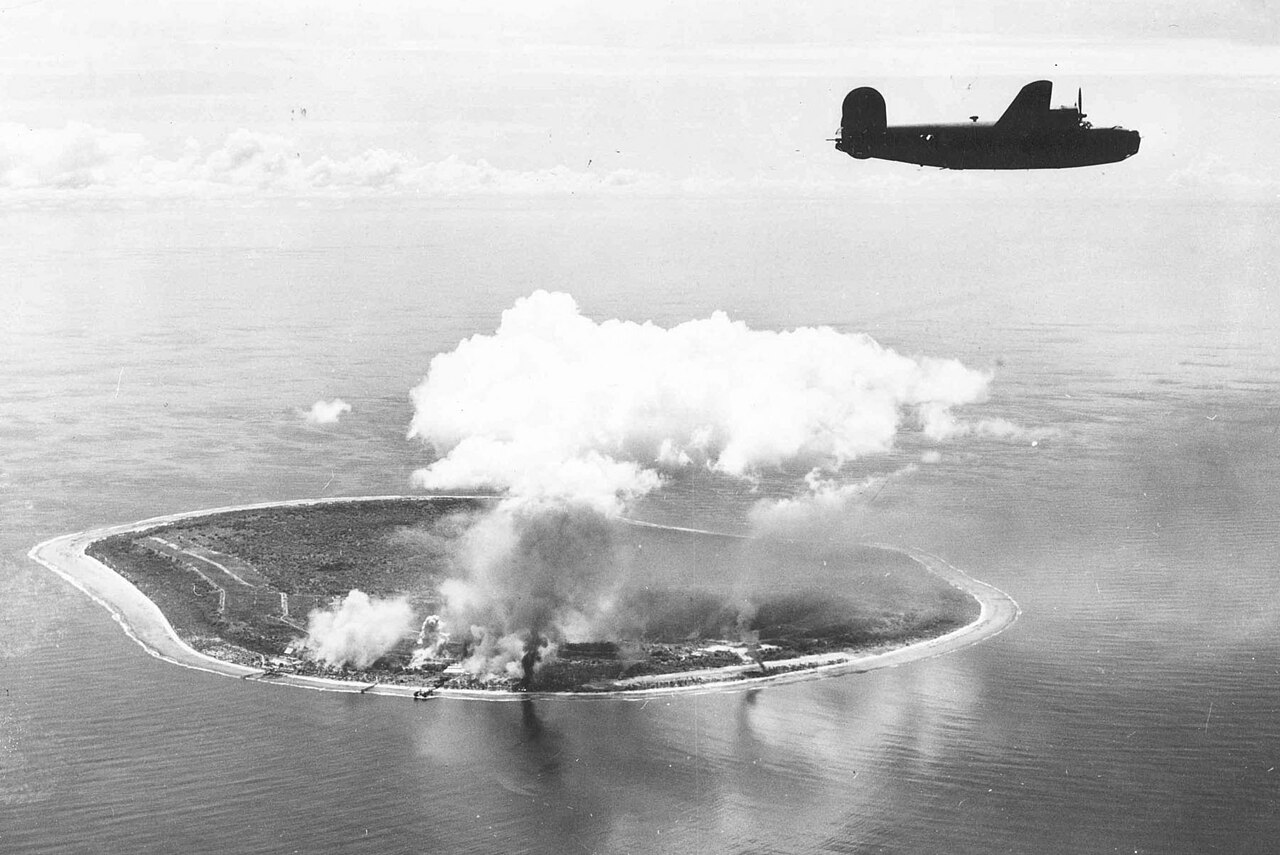 World War II aerial photograph of Nauru Island under US bomber attack showing the island's compact shape and central plateau
