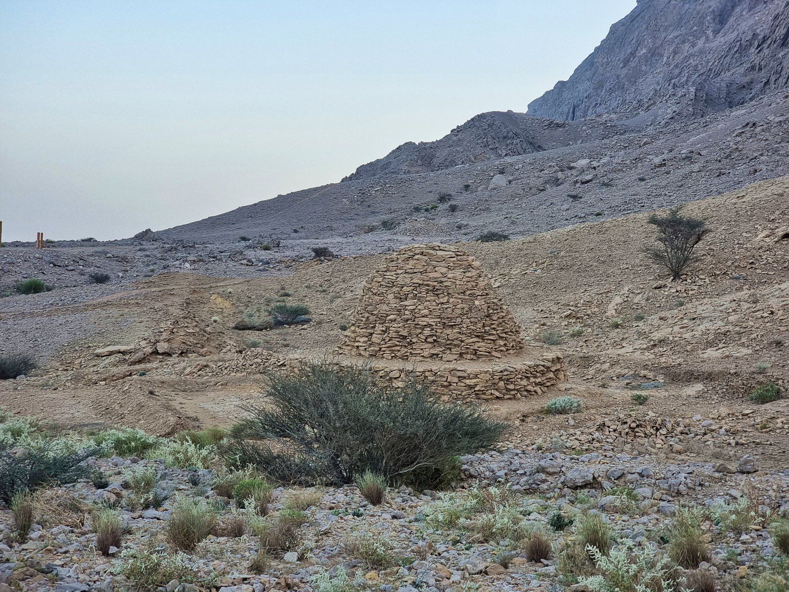 Stone beehive tomb structures on the rocky slope of Jebel Hafit, Al Ain, UAE