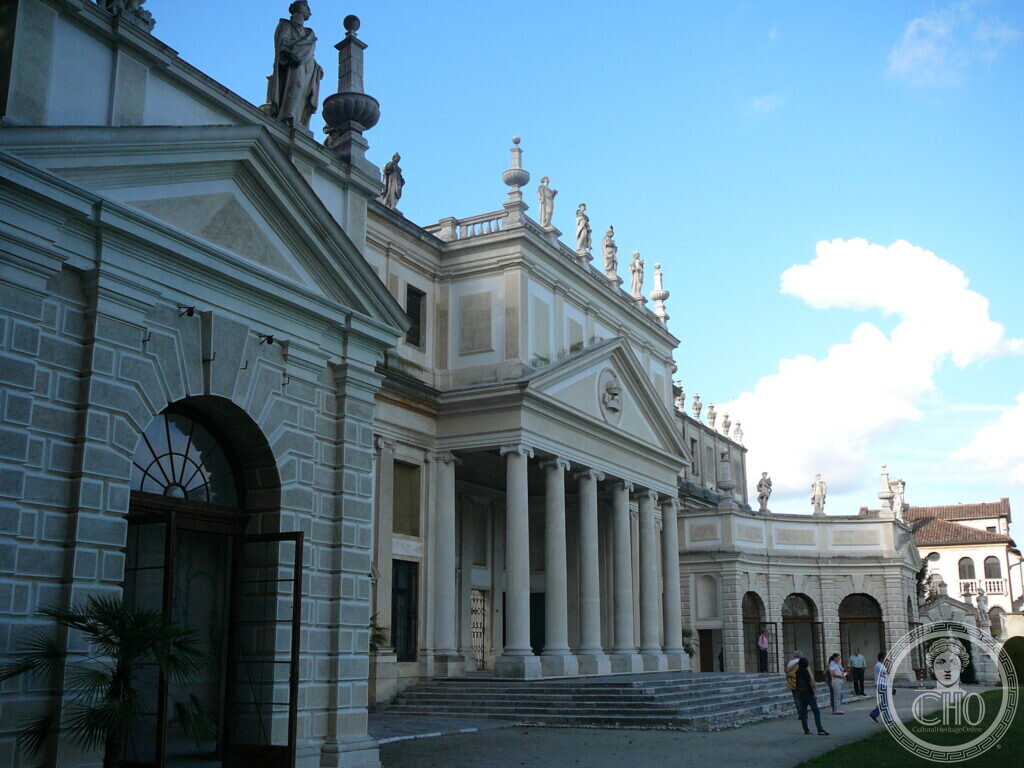 The columned portico of Villa Pisani at Stra, statues along the roofline and a curved wing with arches beyond