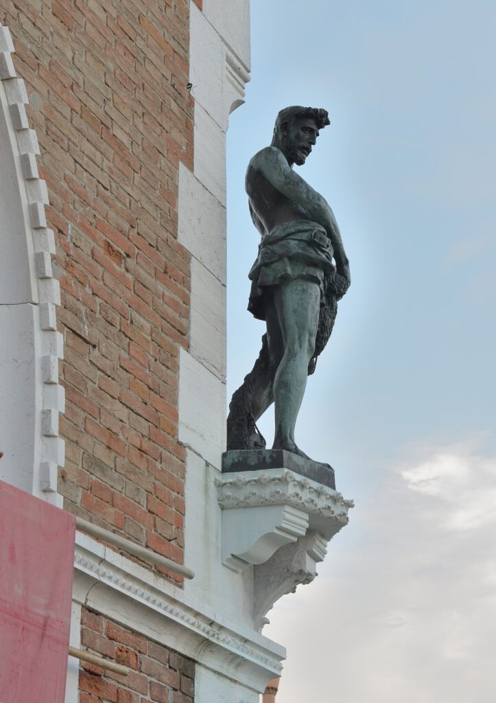 The bronze fisherman by Cesare Laurenti, representing Saint Peter, at the corner over the Grand Canal