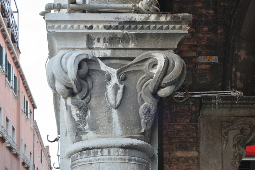 A capital carved as an octopus, its suckers picked out one by one, signed C. LAVRENTI on the abacus