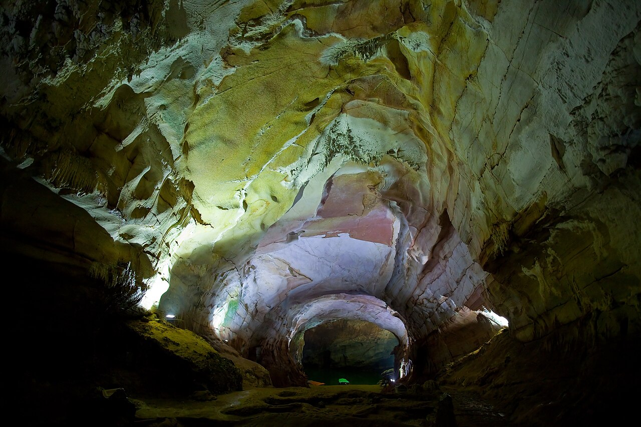 The interior of one of the cave systems within Phong Nha-Kẻ Bàng National Park, central Vietnam — vast underground chambers with stalactites and stalagmites formed over millions of years in the ancient Annamite karst, part of the UNESCO World Heritage property inscribed in 2003 and extended in 2015