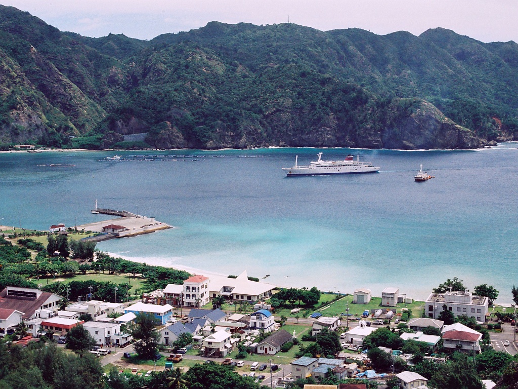 Port of Futami on Chichijima island showing the harbour surrounded by subtropical forest hills, Ogasawara Islands