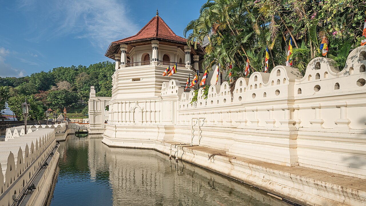 The golden-roofed Temple of the Sacred Tooth Relic on the shores of Kandy Lake, Sri Lanka