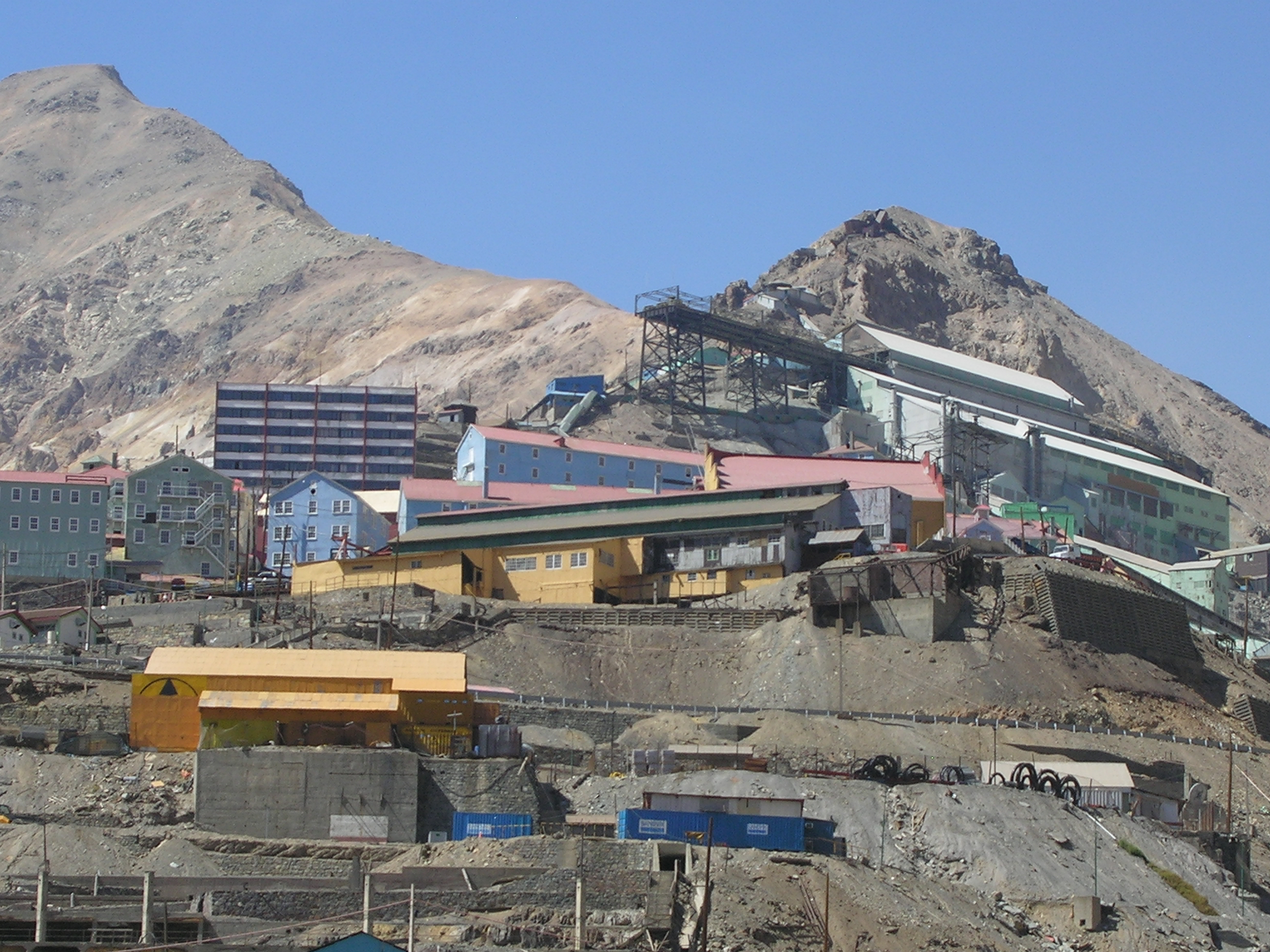 Colourful wooden houses of Sewell Mining Town climbing a steep Andean ridge in Chile