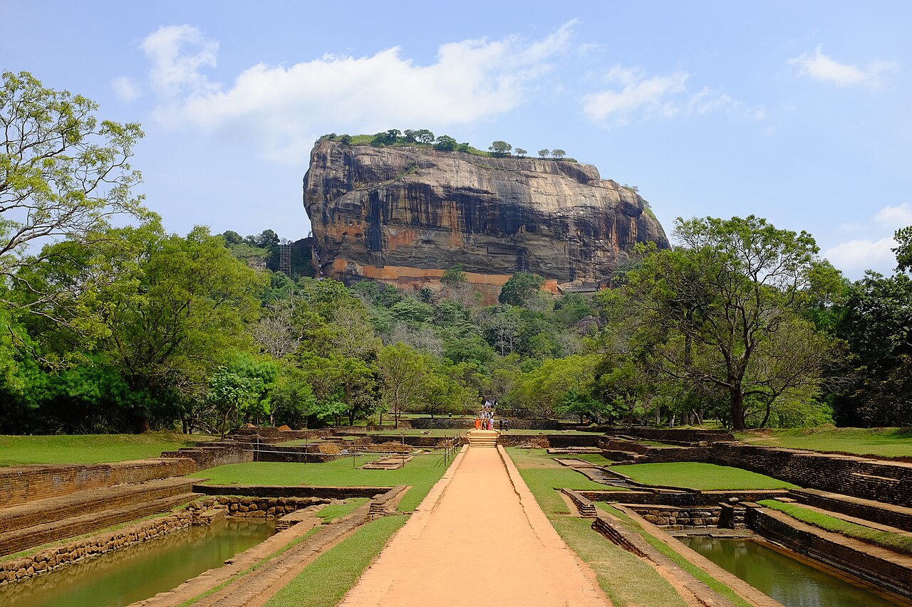 The sheer granite face of Sigiriya Rock rising 200 metres above the surrounding plains, Sri Lanka