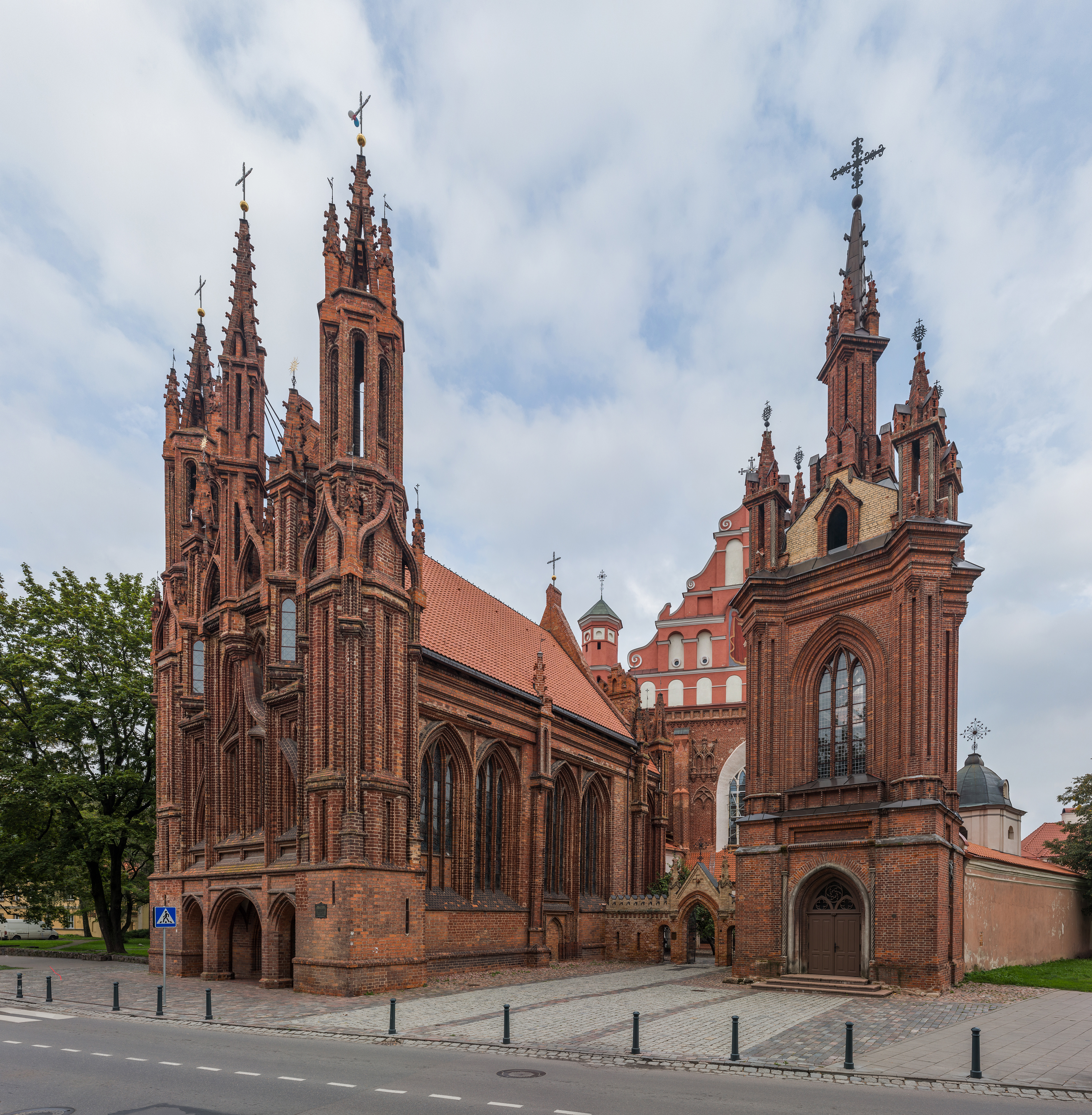 Ornate red-brick Gothic facade of St Anne's Church in Vilnius against a clear sky