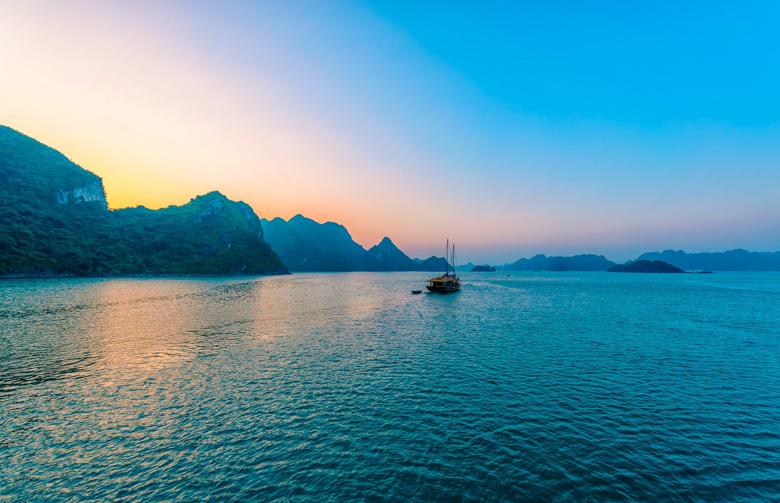 Sunset light across limestone islands of Ha Long Bay Vietnam