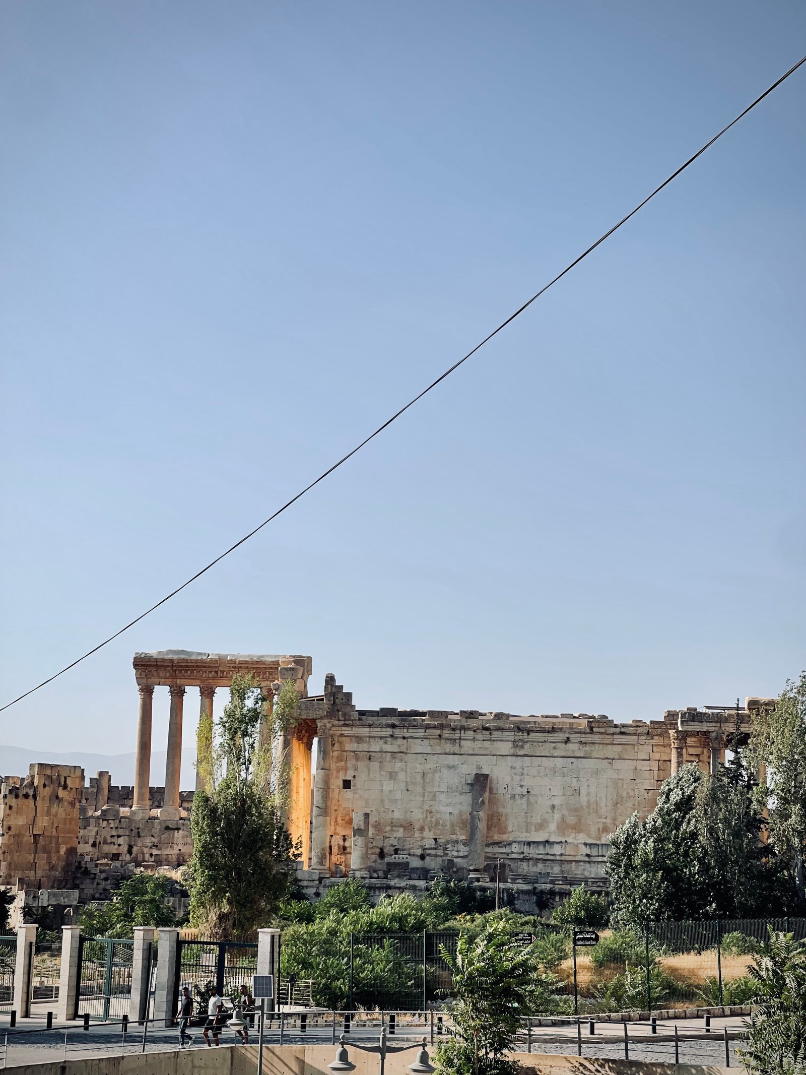 Six standing columns of the Temple of Jupiter at Baalbek against a blue sky