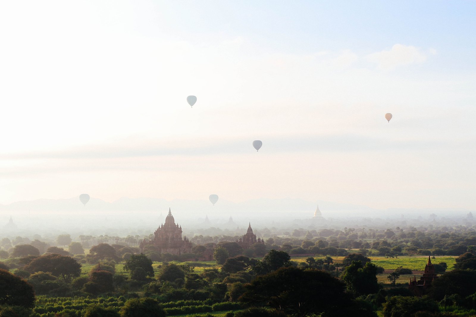 Hot air balloons drifting over Bagan temple spires at dawn, Myanmar