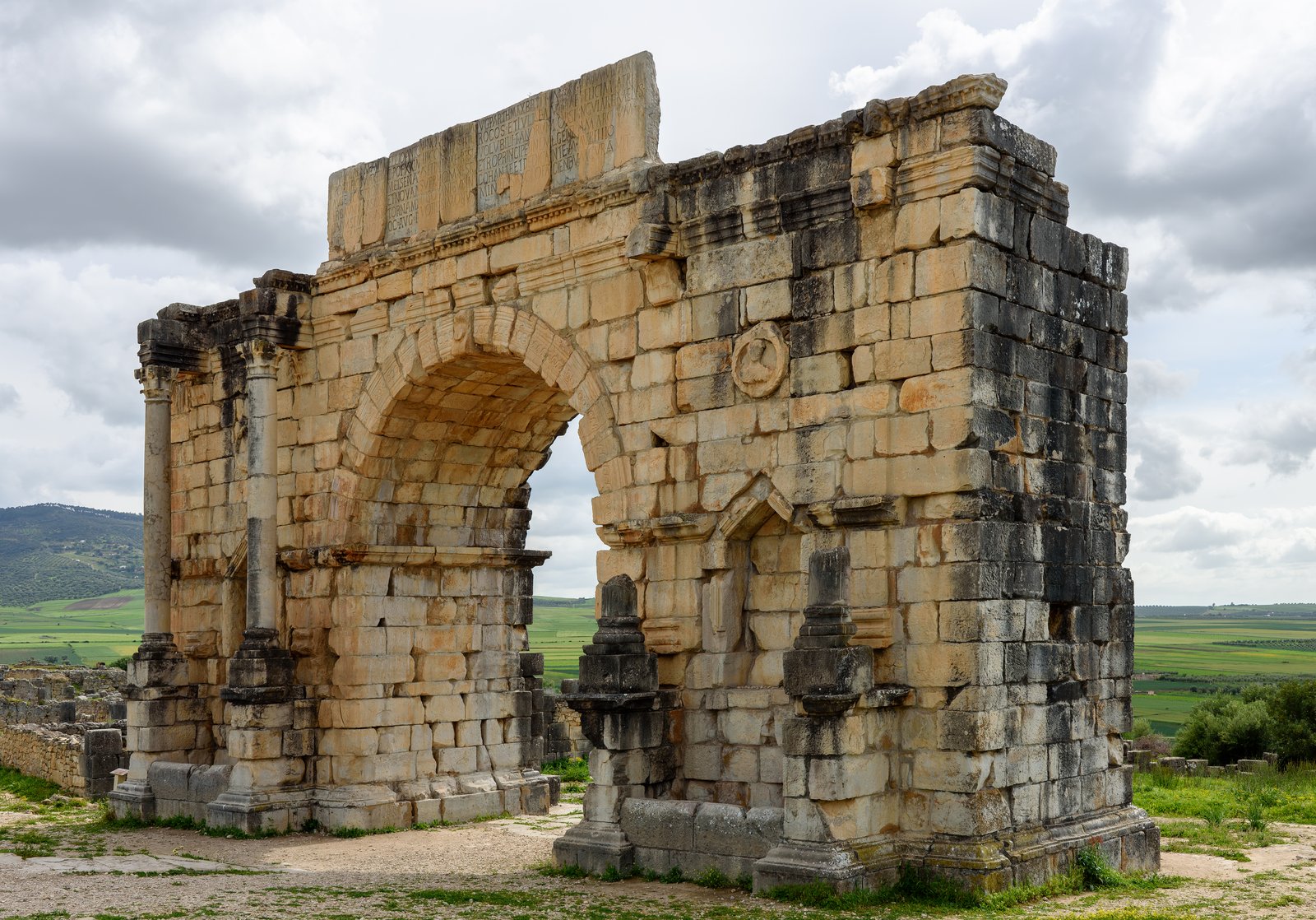 Triumphal Arch of Caracalla standing against blue sky at the Roman city of Volubilis Morocco