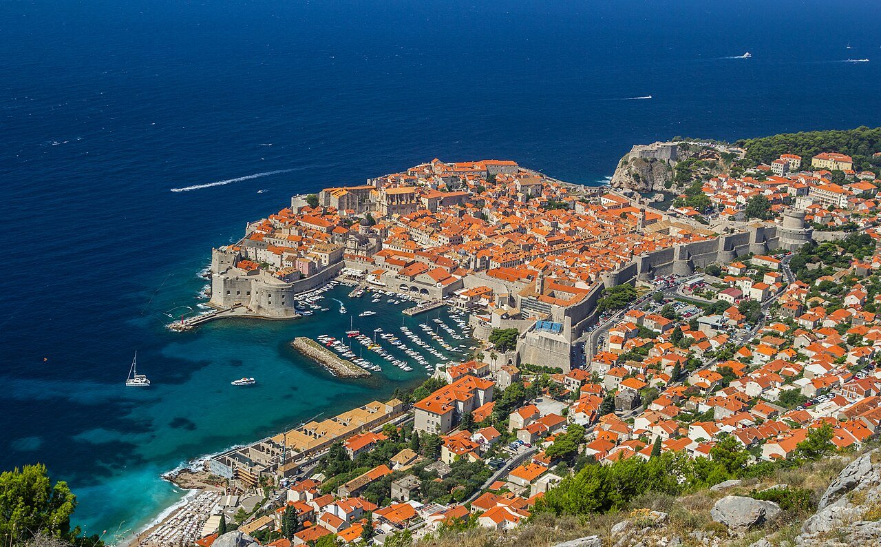 Panoramic view of the Old City of Dubrovnik showing the complete circuit of medieval walls and red-roofed buildings within