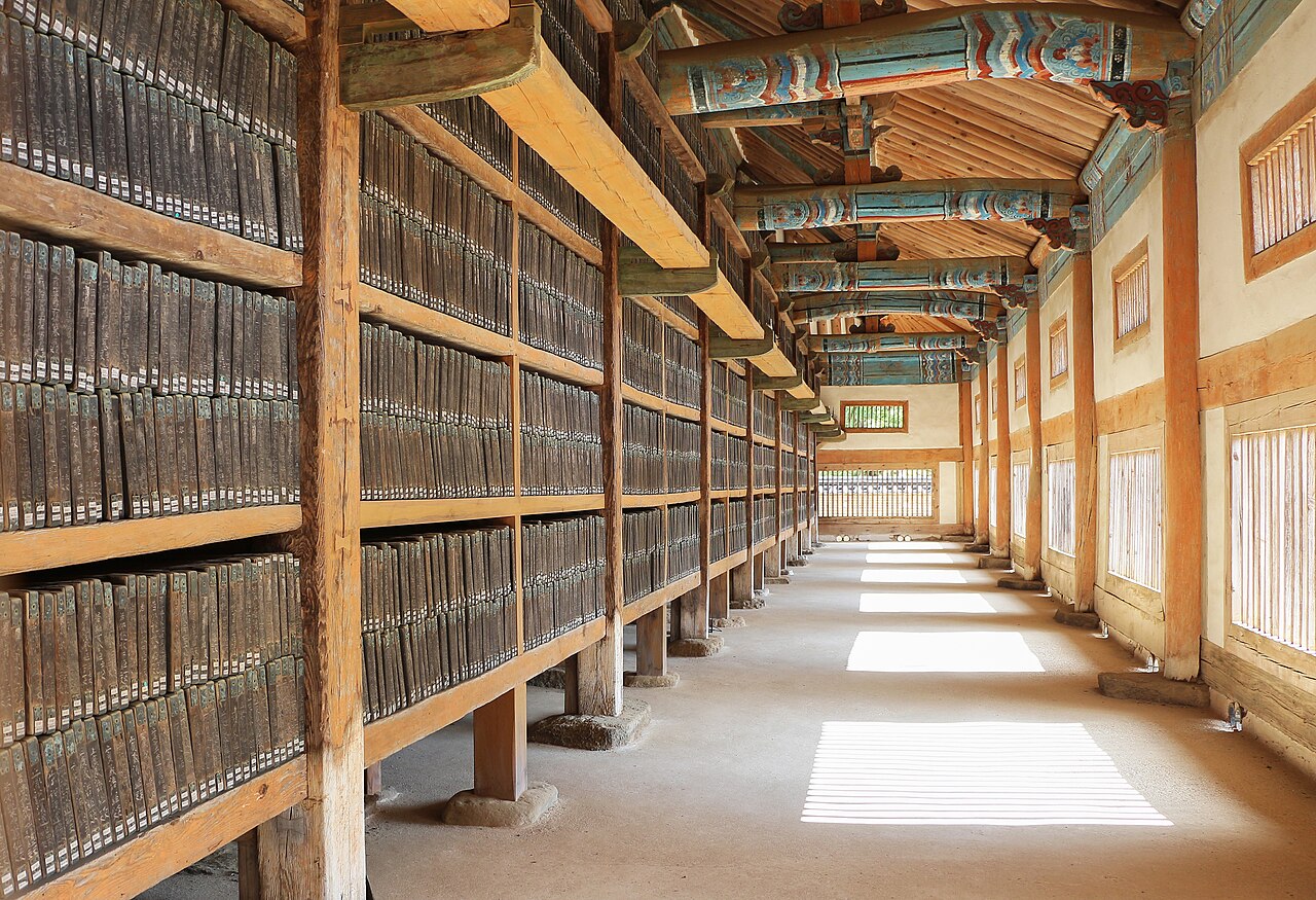 Long rows of wooden Tripitaka Koreana printing blocks stored on slatted shelves in the 13th-century Janggyeong Panjeon repository buildings at Haeinsa Temple, South Korea, showing the ventilation system designed to preserve the Buddhist canon