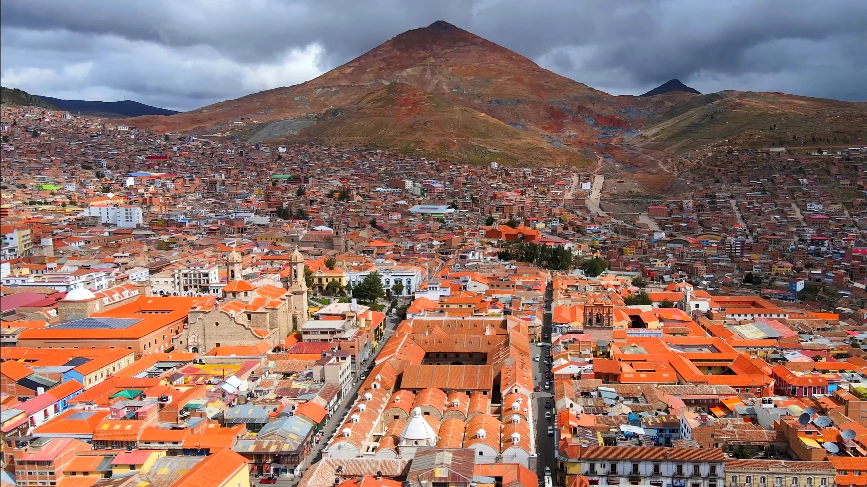 Panoramic view of Potosí with the conical Cerro Rico silver mountain dominating the skyline above the colonial city of white church towers and terracotta-roofed houses