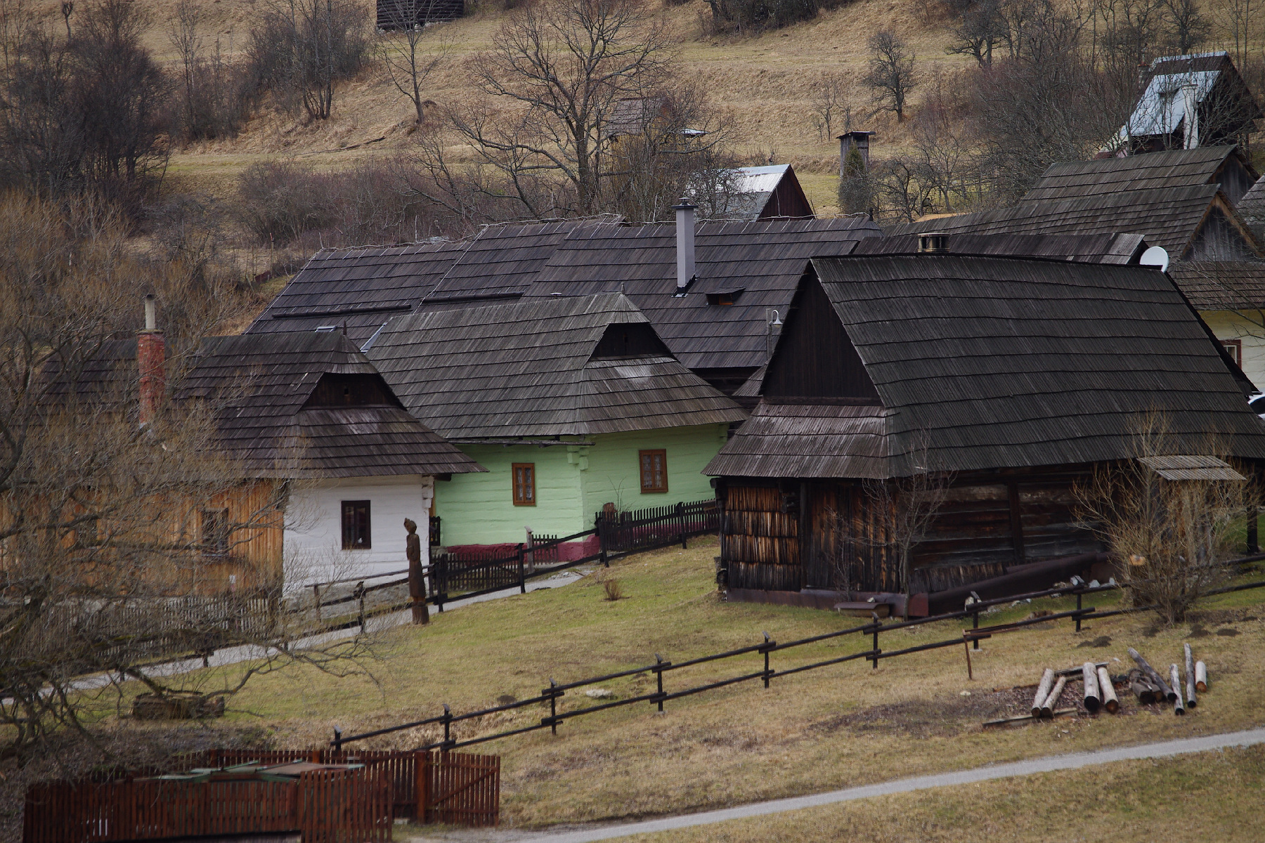 Traditional log houses with painted facades lining the main street of Vlkolinec village Slovakia