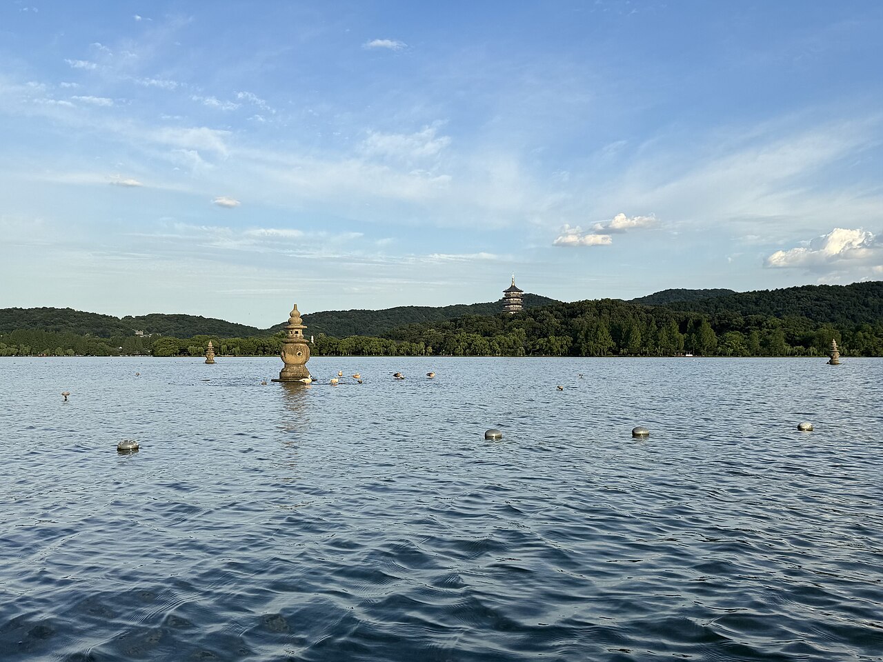 West Lake (Xihu) in Hangzhou, Zhejiang, China — a UNESCO-listed freshwater lake with causeways, pagodas, and temple islands surrounded by hills, the archetypal Chinese picturesque landscape