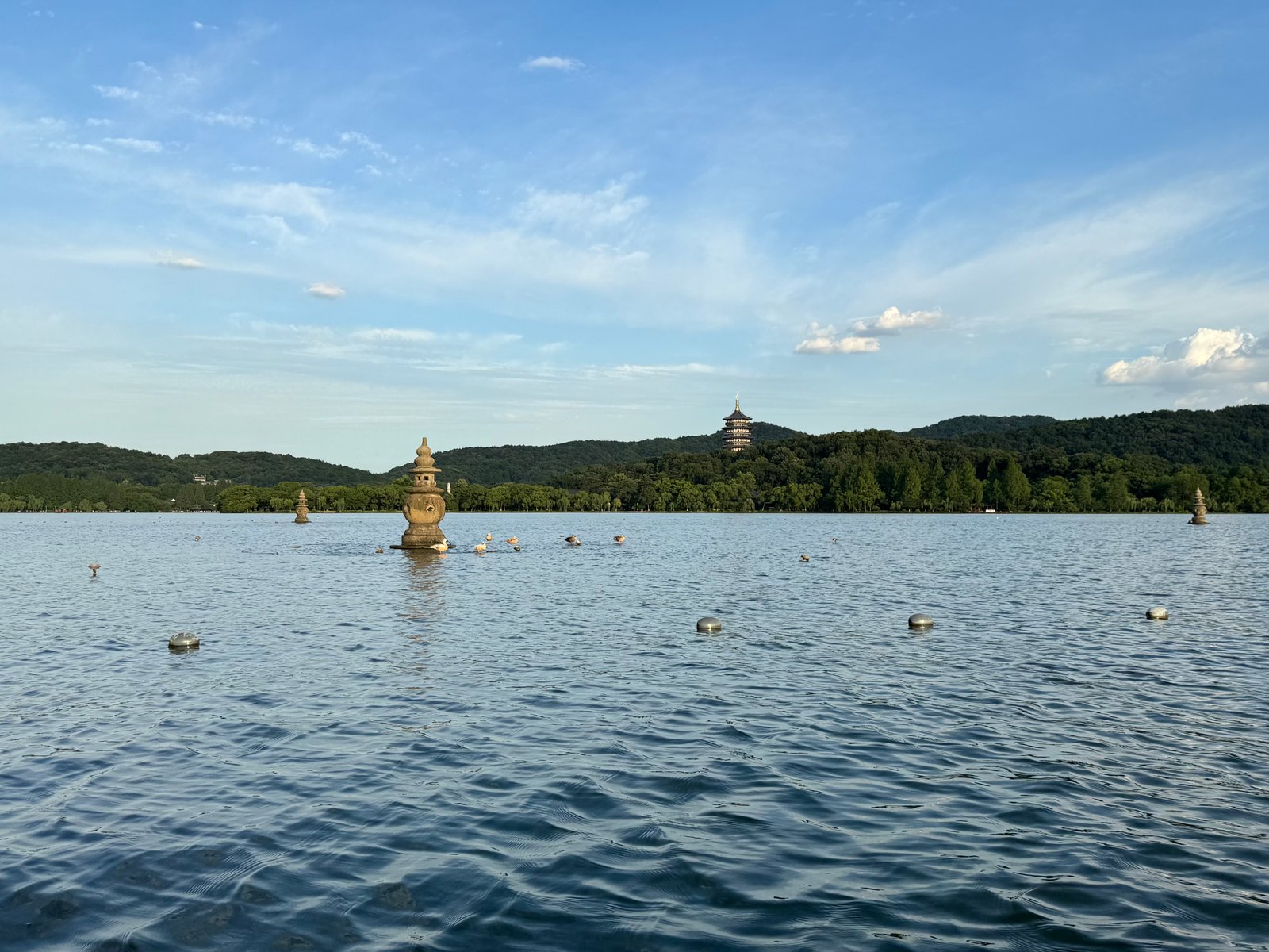 Three Pools Mirroring the Moon island with Leifeng Pagoda rising beyond the still surface of West Lake