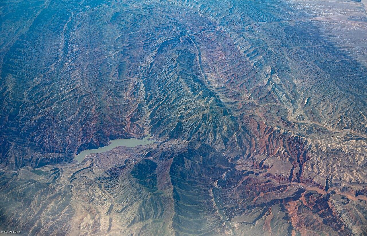 Snow-capped peaks forested valley Tianshan mountains Xinjiang China