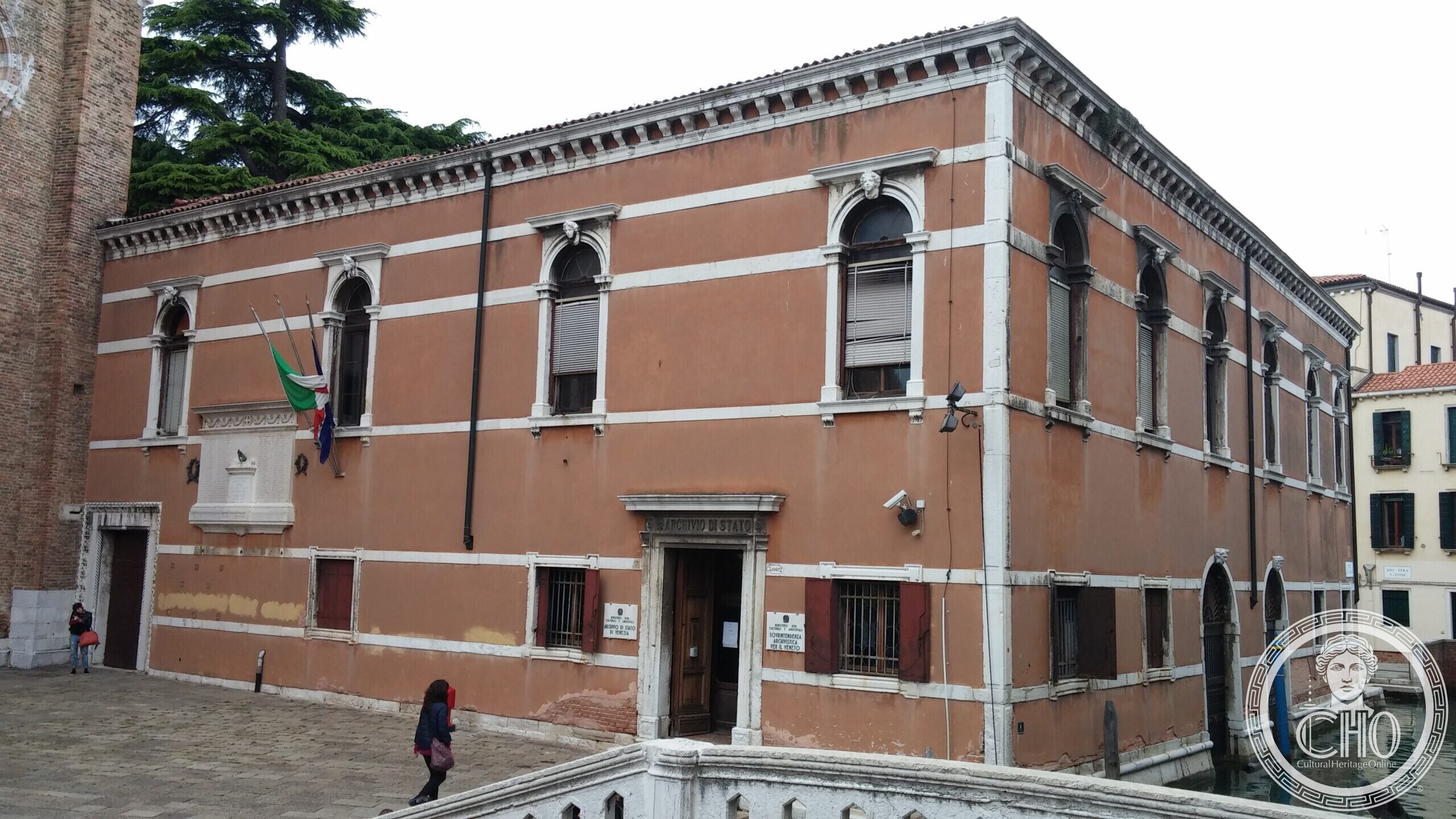 The entrance of the State Archive of Venice in the former Frari convent, with flags over the door