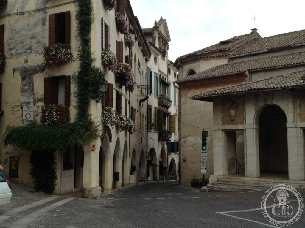 Arcaded street in the historic centre of Asolo with flower boxes on every window
