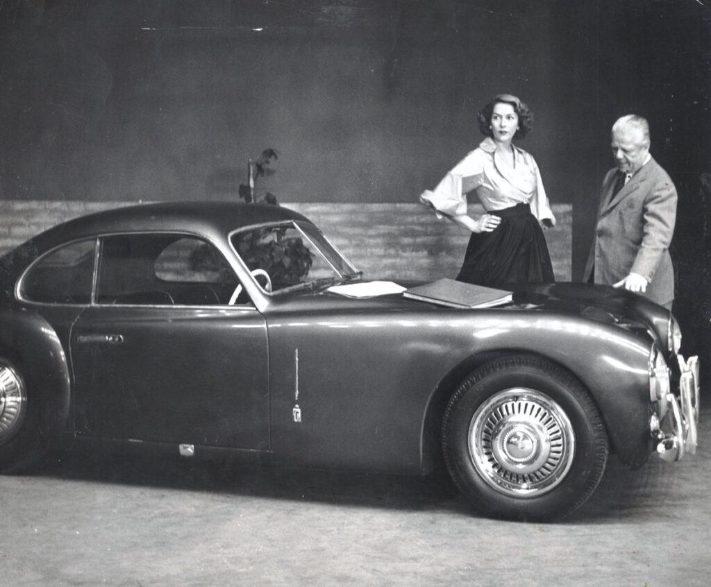 Battista 'Pinin' Farina standing beside the newly launched Cisitalia 202 coupe