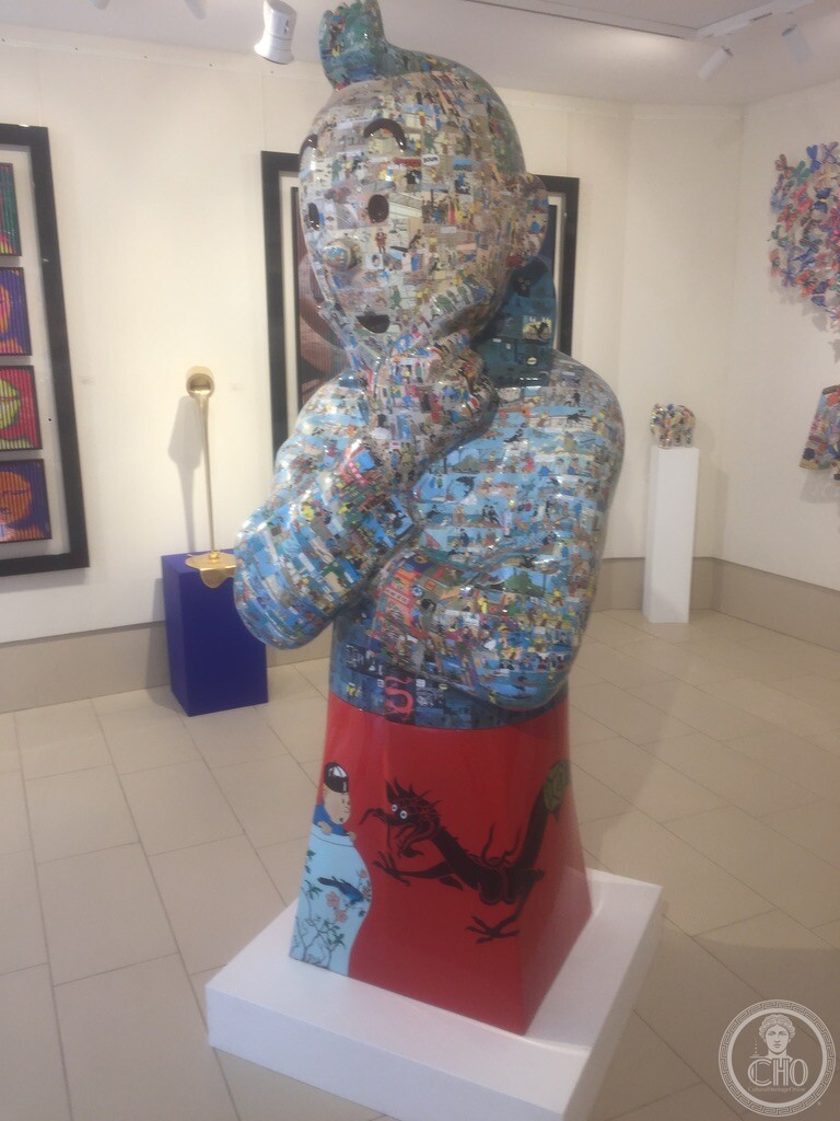 Sculpted bust covered in comic strips on pedestal at Bel-Air Fine Art, Dorsoduro, Venice