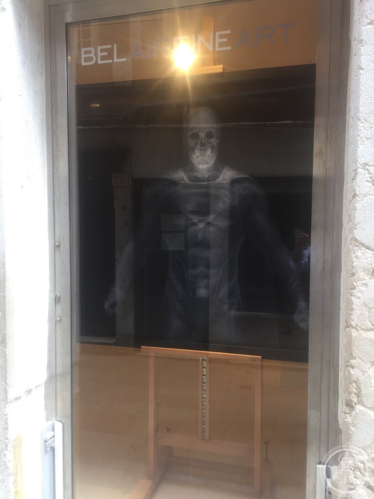 Artwork depicting Superman in x-ray form on display behind the frosted window of Bel-Air Fine Art, Dorsoduro, Venice