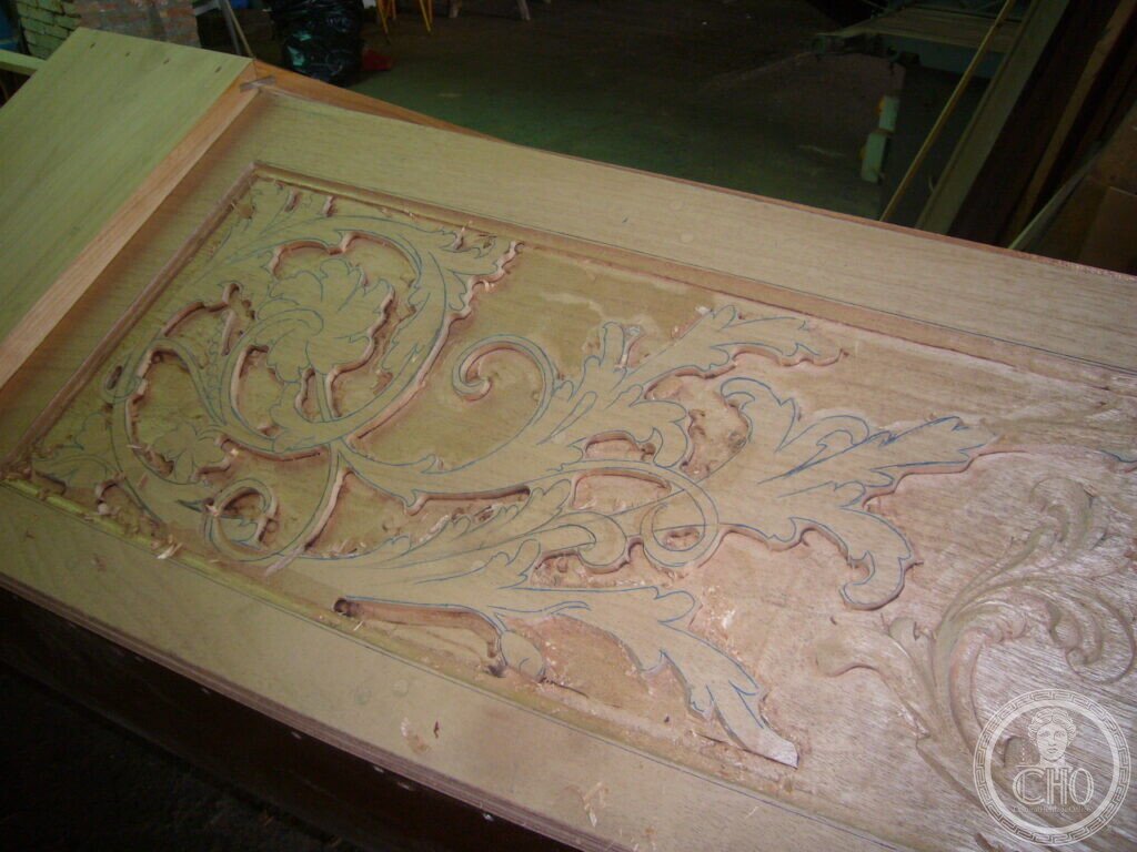 Close detail of acanthus foliage ornament being carved into a gondola deck board